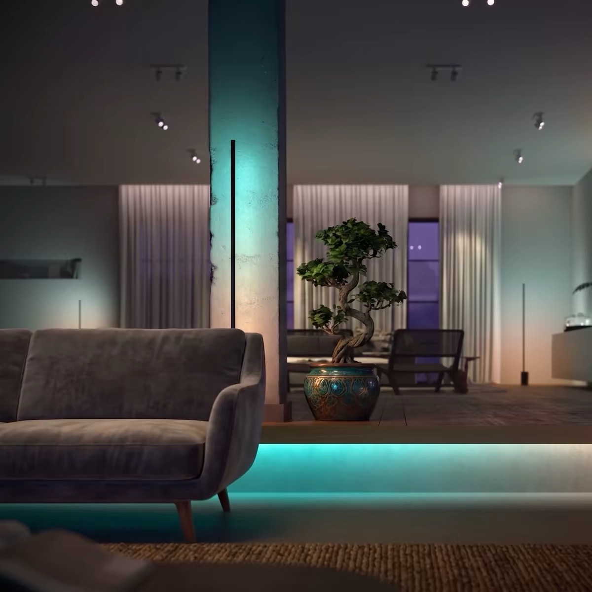 Floor lamps beside columns and cyan accent light along a raised floor