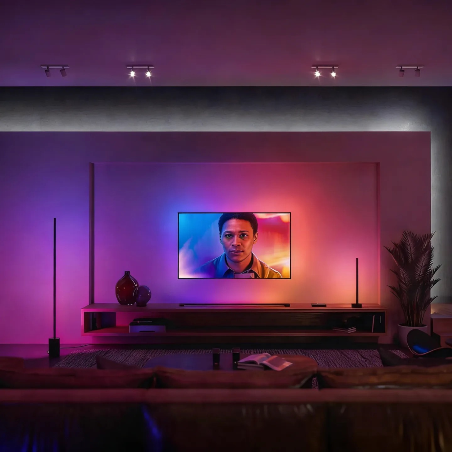 A television wall with floor, table and horizontal tube lighting